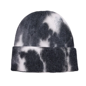 Close-up of tie-dye knit beanie showing detailed black and white wool texture and cuff