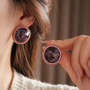 Elegant round resin earrings with purple stones and pink crystals in gold plating