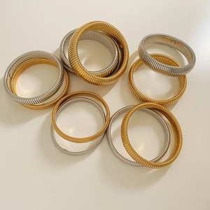 Macro shot of gold and silver snake bone elastic bracelets in various thickness options