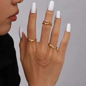 Detailed view of gold multi-finger ring chain bracelet with star and butterfly charms