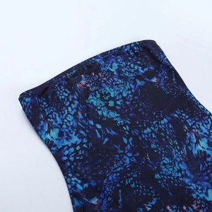 Close-up of blue abstract print on sexy mini dress showing fine stitching and fabric texture