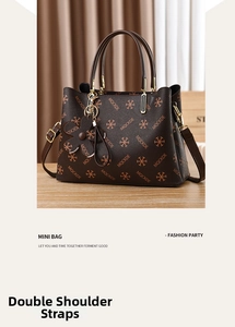 Detail of monogram print tote with black flower charm and double shoulder straps