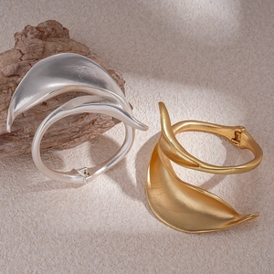 Artistic leaf design open cuffs in gold and silver finish with matte metal texture