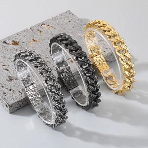 Detail of hammered texture cuban link bracelets in silver, black and gold finishes