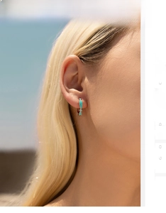 Detail of S925 sterling silver hoop earrings with mint green enamel geometric pendants