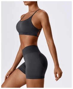 Detail of seamless knitted workout set featuring thin strap bra and high waist shorts