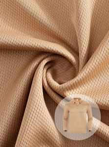 Close-up of khaki polo shirt showing breathable honeycomb knit texture and chest pocket