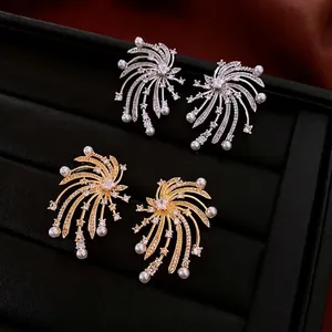 Star-shaped firework stud earrings with crystals and pearls in gold and silver plating