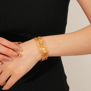 Detail of 18k gold plated grid pattern cuff bracelet shown on a model wrist