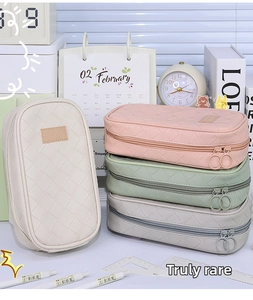 Detail of woven lattice texture on multi-layer pencil cases in various pastel colors