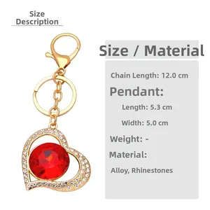 Detailed macro view of golden heart keychain featuring a large red central crystal stone