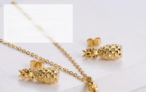 Detailed close-up of a three-piece gold-plated titanium steel pineapple jewelry set