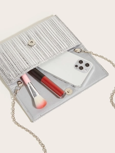 Detail of silver pleated evening bag showing interior space for phone and makeup