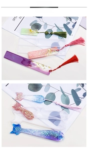 Detail of DIY resin bookmark molds with colorful tassels and shimmering cat shapes