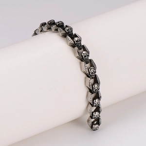 Retro stainless steel skull bracelet with vintage silver finish on white display stand