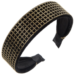 Detail of black velvet headband featuring golden rhinestone grid pattern and padded edges