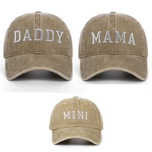 Detail view of khaki washed cotton baseball caps with Daddy, Mama, and Mini embroidery