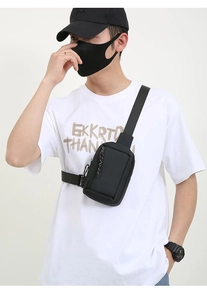Close-up of waterproof black crossbody chest bag with adjustable strap and zip pocket