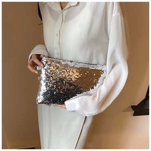 Detail of high-density sequin clutch bag showing silver and champagne gold texture