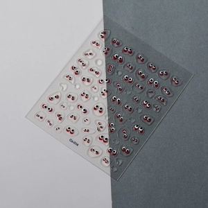 Macro detail of transparent nail stickers featuring red and black cute eye designs Co-014