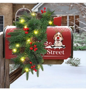 Christmas mailbox cover with pine cones, red berries and warm LED lights in snow
