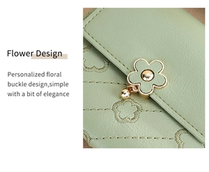 Detailed macro view of light green textured leather wallet with flower buckle and embroidery