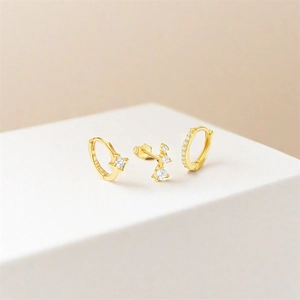 Detail of S925 sterling silver stamp on gold earring set with zircon crystals