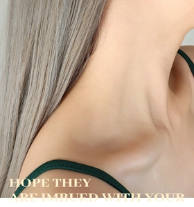 Close-up of elegant dark green camisole top featuring minimalist thin shoulder straps