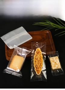 Macro shot of food-grade transparent plastic seal bags with serrated edges on wood