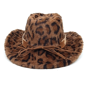 Detailed view of leopard print plush cowboy hat with brown leather bow accessory