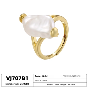 Detailed macro shot of vintage brass sunflower ring with a large baroque pearl