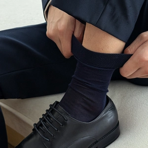 Men's navy silk business socks showing high elasticity cuff and tight knit texture