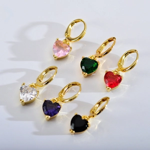 Detail view of heart-shaped zircon charms in six colors hanging from golden hoops