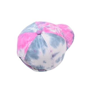 Detail of pink tie-dye baseball cap featuring distressed holes and metal buckle