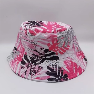 Detail view of tropical monstera leaf print pattern on reversible summer bucket hat