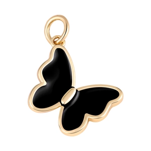 Close-up of golden butterfly pendant with black enamel inlay and zircon stone accents
