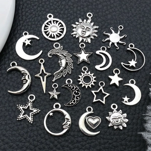 Detail of silver alloy celestial charms featuring star, moon, and sun shapes for DIY jewelry