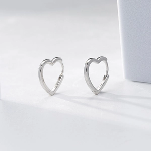 Close-up of S925 sterling silver heart hoop earrings showing the 925 authenticity hallmark