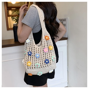 Detail of handmade crochet flower tote bag featuring colorful 3D blossoms on ivory mesh