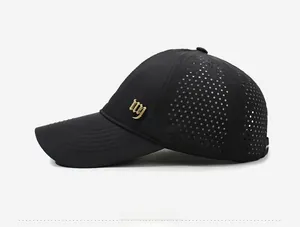Detail view of breathable laser-cut holes and gothic metal logo on black sports cap