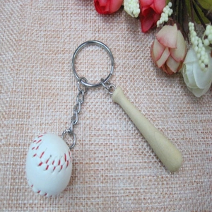 Detail of mini wooden baseball bat and white stitched ball charm on a silver keychain