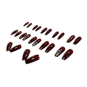 Glossy deep cherry red coffin fake nails with silver abstract faces and striped patterns