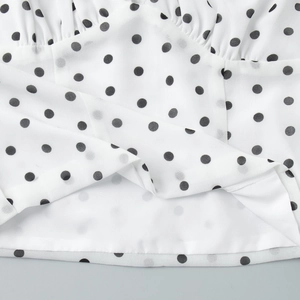 Detailed macro view of white and black polka dot chiffon skirt with soft inner lining