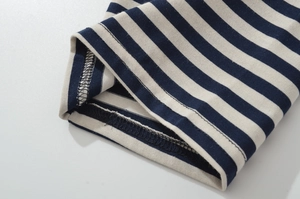 Detail of navy and white striped knit cuff with high-quality double-needle stitching