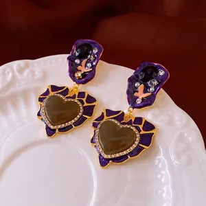 Vintage heart drop earrings with purple enamel, pearls, and crystals in a luxury retro style