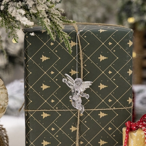 Detailed view of a transparent acrylic angel ornament hanging on a festive gift box