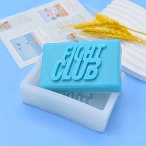 Silicone mold for soap making with embossed Fight Club text and blue soap bar