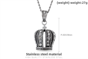 Close-up of crown pendant necklace with inset white crystals and twisted metal chain