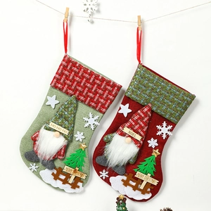 Pair of large 3D gnome Christmas stockings in red and green burlap for gift bags