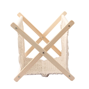 Detail of bohemian cotton rope weave and foldable wooden frame for magazine rack